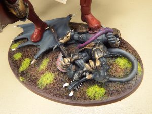 This custom Sisters of Battle Knight Titan is crushing a fallen daemon prince under its heel.